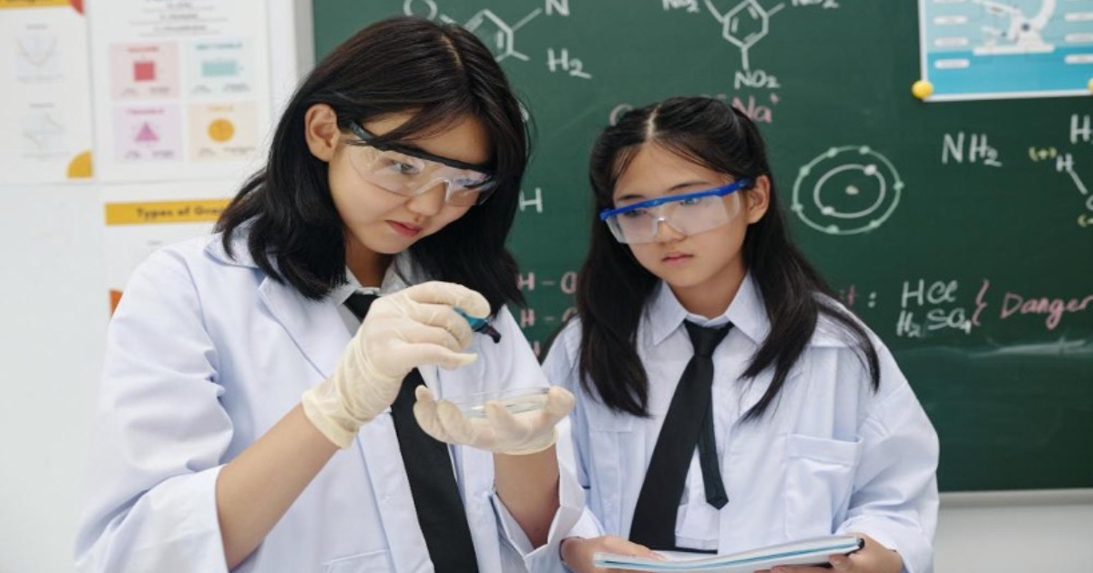 Combined science tuition Singapore student reviewing improved O-Level exam results with tutor