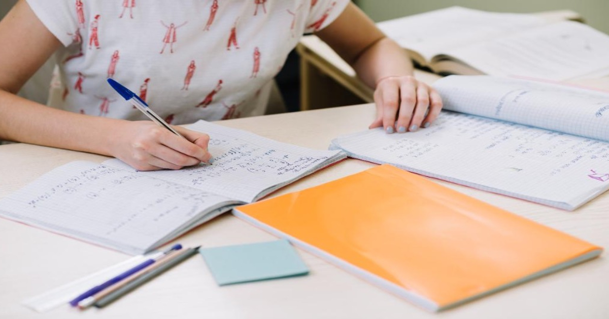 H2 maths tuition Singapore JC student solving a calculus problem with a tutor