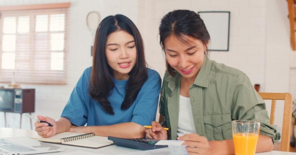 PSLE maths tuition Singapore tutor guiding a primary school student through a worksheet