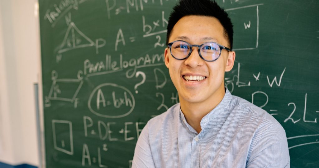 Secondary 3 student solving an O-Level physics circuit question with a tutor at a tuition centre in Katong, Singapore